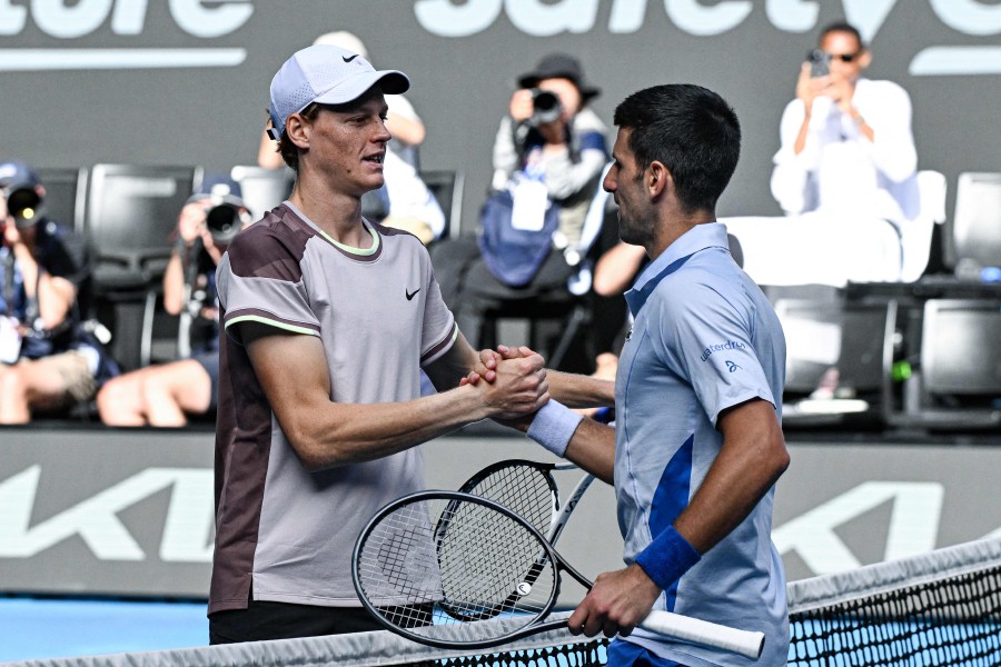 Italy's Jannik Sinner greets Serbia's Novak Djokovic (R) after victory in their men's singles semi-final match on day 13 of the Australian Open tennis tournament in Melbourne. - AFP PIC