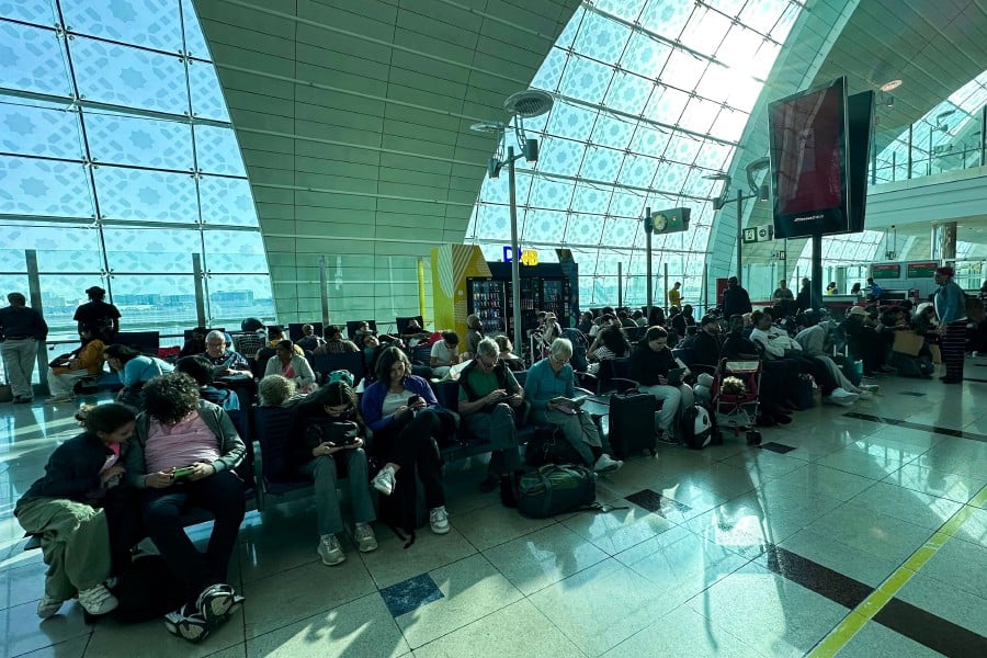 Passengers wait for their flights at the Dubai International Airport in Dubai on April 17, 2024. -AFP PIC