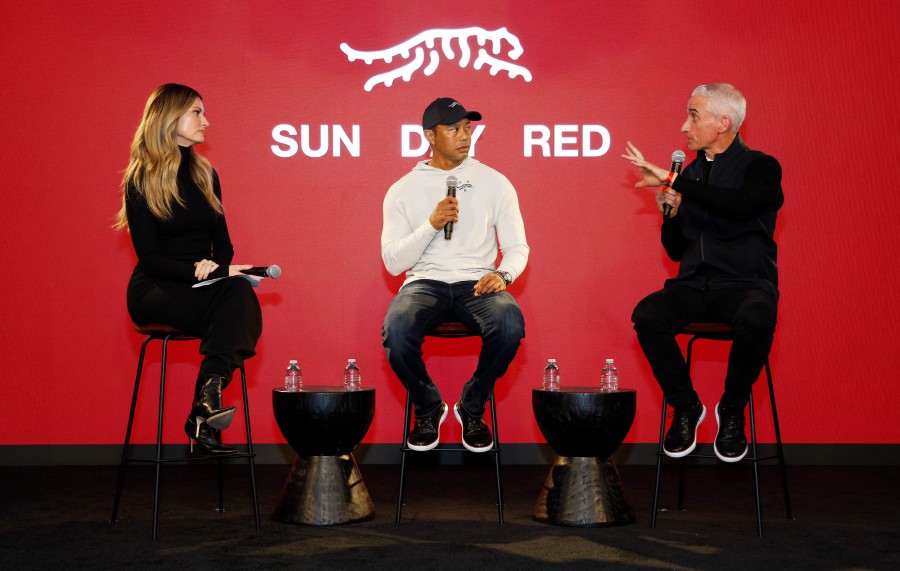  (L-R) Erin Andrews, Tiger Woods and CEO and President at TaylorMade, David Abeles attend the launch of Tiger Woods and TaylorMade Golf's new apparel and footwear brand "Sun Day Red" at Palisades Village in Pacific Palisades, California. - AFP PIC