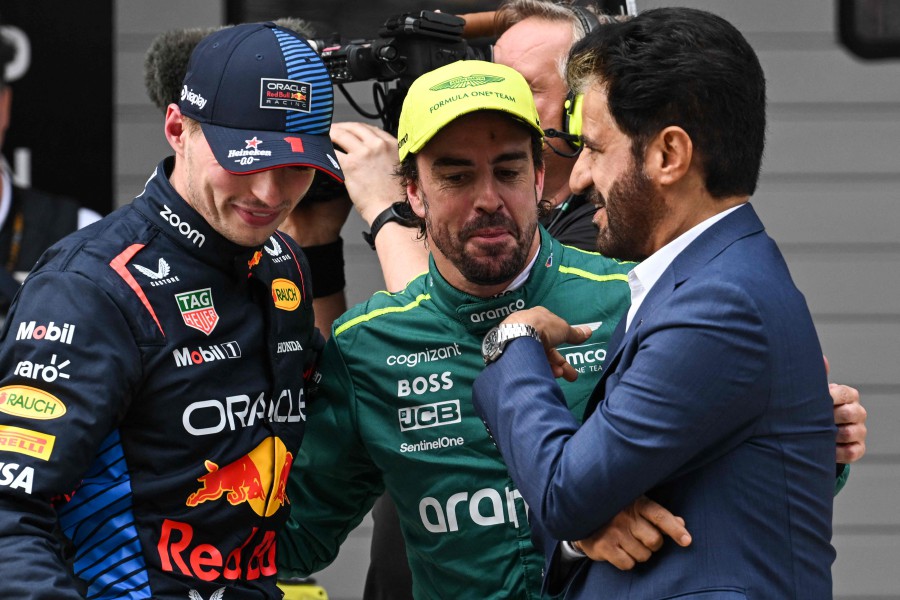 Red Bull Racing's Dutch driver Max Verstappen (L), Aston Martin's Spanish driver Fernando Alonso (C) and Mohammed Ahmad Sultan Ben Sulayem (R), president of the FIA, talk after the qualifying session for the Formula One Chinese Grand Prix at the Shanghai International Circuit in Shanghai. - AFP PIC