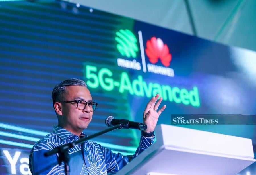 Communications Minister Fahmi Fadzil delivers his keynote address during the launch of the Maxis 5G-Advances Trial Showcase at Suria KLCC. - NSTP/ASWADI ALIAS
