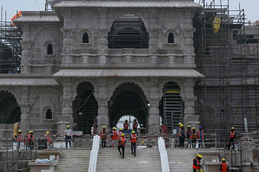 Workers are pictured at the construction site of a temple to Hindu deity Ram, in Ayodhya on December 29, 2023. - APF PIC