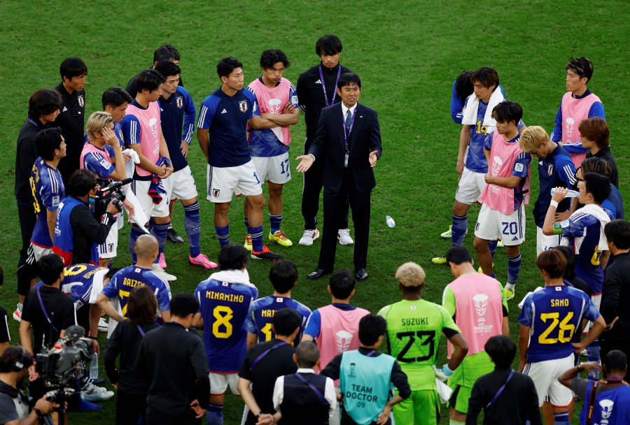 Japan coach Hajime Moriyasu speaks to the players and coaches after the match against Indonesia at the Al Thumama Stadium, Doha. - REUTERS PIC