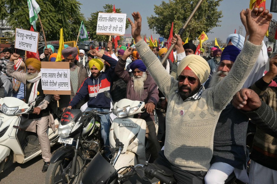  Farmers shout slogans during a protest demanding minimum crop prices in Amritsar. - AFP PIC