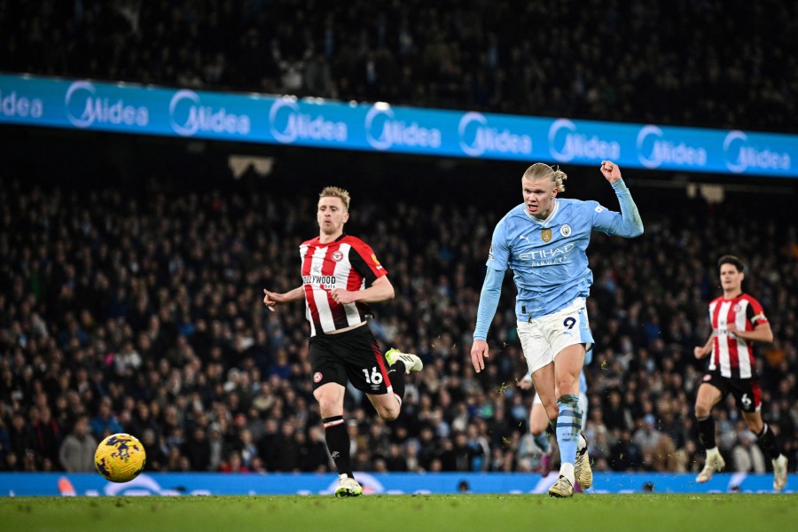 Manchester City's Erling Haaland shoots and scores his team first goal against Brentford at the Etihad Stadium in Manchester. - AFP PIC