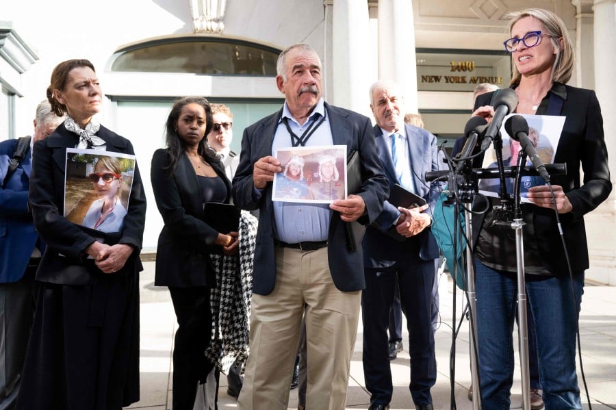 Naoise Connolly Ryan (R), whose husband Mick Ryan was killed in the Ethiopian Airlines Flight 302 Boeing 737 MAX crash, stands with other family members of victims, including Ike Riffel (C), whose sons Melvin and Bennett were killed, and Catherine Berthet (L) of France, whose daughter Camille was killed, during a press conference after meeting with Department of Justice officials over concerns about how the US government has handled the criminal prosecution into Boeing, outside a government office in Washington. - AFP PIC
