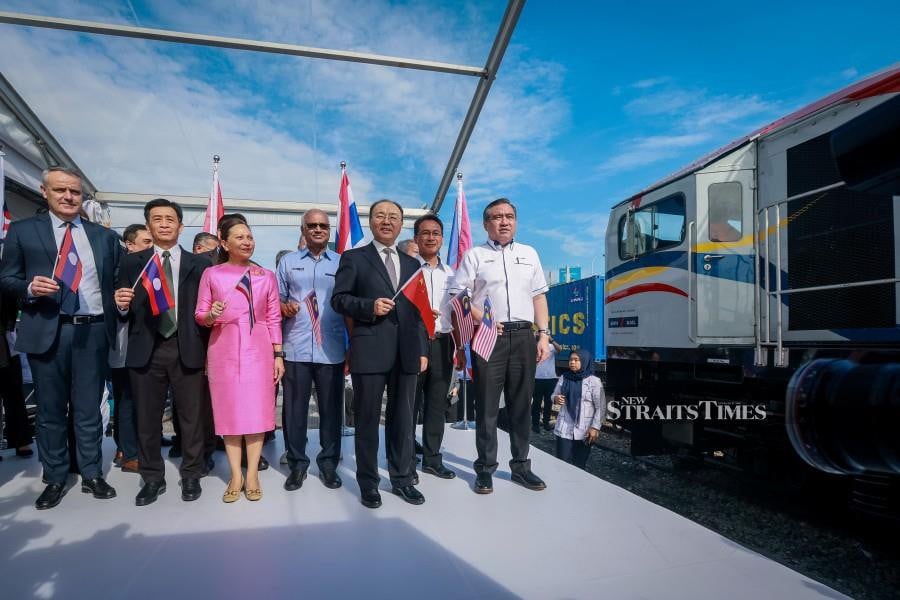 Transport Minister Anthony Loke (right) with KTMB Group chief executive officer Datuk Mohd Rani Hisham Samsudin (2nd-right) during the ceremony at the Kontena Nasional Inland Clearance Depot in Petaling Jaya. -NSTP/ASYRAF HAMZAH