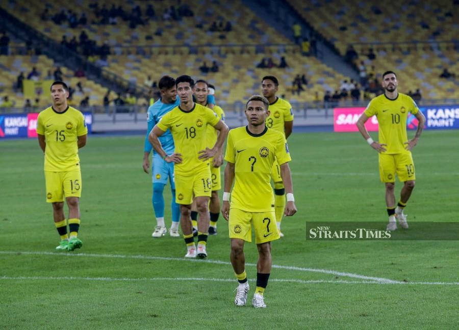 Deject Harimau Malaya players leave the pitch after losing 2-0 to Oman at the National Stadium in Bukit Jalil on March 26. -NSTP/HAZREEN MOHAMAD