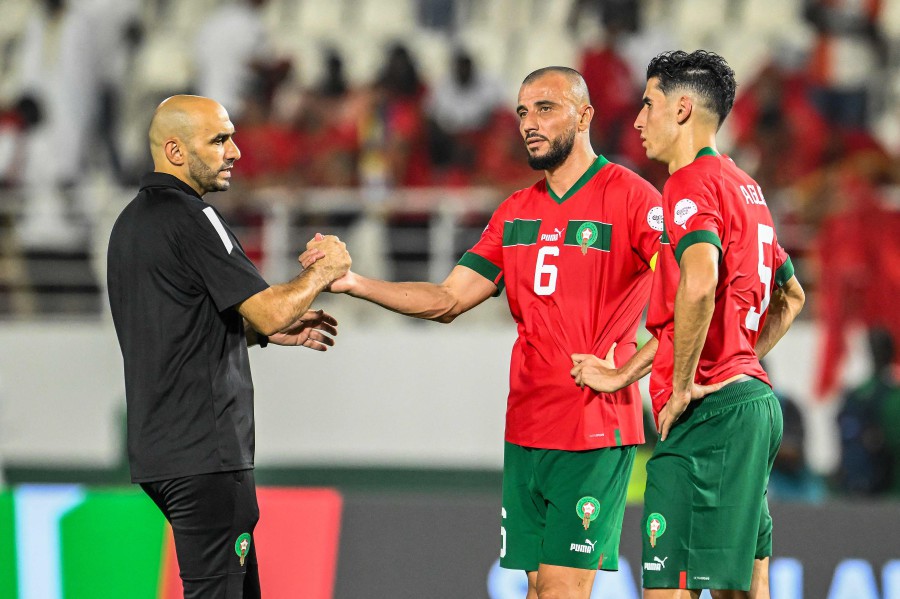 Morocco's coach Walid Regragui (L), Romain Saiss (C) and Nayef Aguerd (R) react after their loss in the Africa Cup of Nations (CAN) 2024 round of 16 football match between Morocco and South Africa at the Stade Laurent Pokou in San Pedro. - AFP PIC