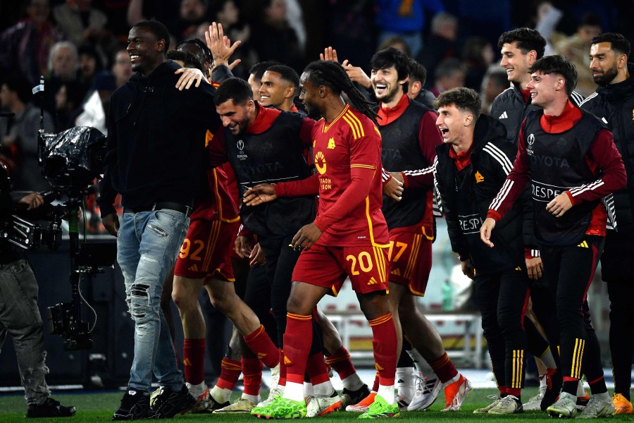 AS Roma's players celebrate with teammate Roma's Evan Ndicka (L) after winning the UEFA Europa League football match between AS Roma and AC Milan at the Olympic stadium, in Rome. - AFP PIC