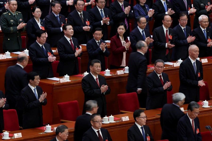 Chinese President Xi Jinping and other leaders attend the closing session of the National People's Congress (NPC) at the Great Hall of the People in Beijing, China. - REUTER PIC