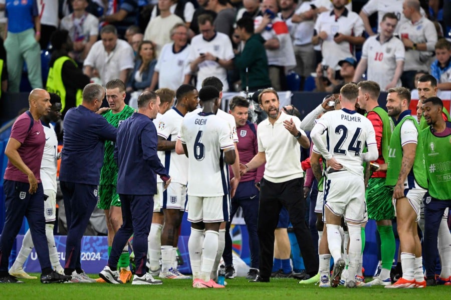 England's head coach Gareth Southgate (C) speaks to his players during the extra time's half time, during the UEFA Euro 2024 round of 16 football match between England and Slovakia at the Arena AufSchalke in Gelsenkirchen. - AFP PIC