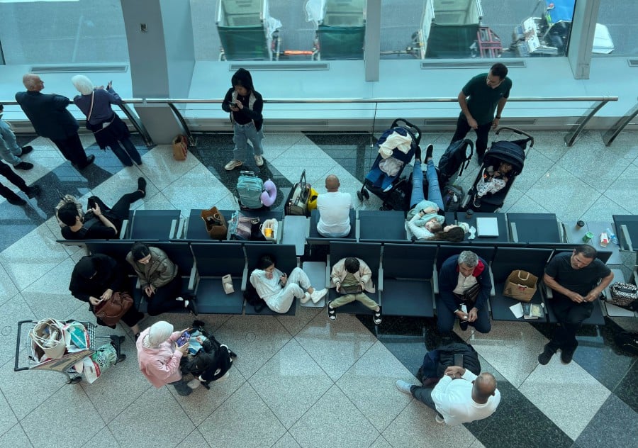 Passengers wait for their flight after a rainstorm hit Dubai, causing delays at the Dubai International Airport, in Dubai, United Arab Emirates. - REUTERS PIC