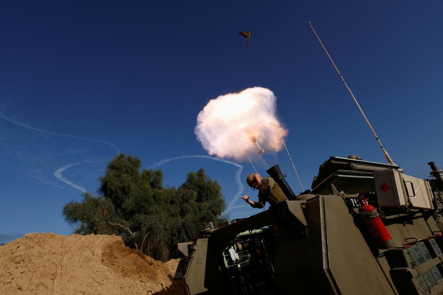 An Israeli soldier reacts while firing a mortar, as the conflict continues between Israel and Hamas, on the border with the central Gaza. - REUTERS PIC