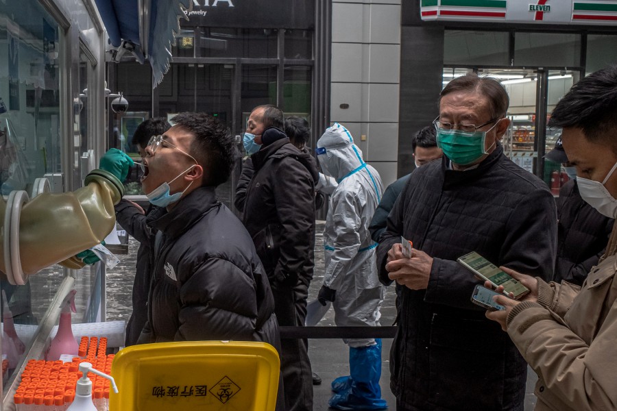  A man is tested for Covid-19 as other wait in a queue, in Beijing, China. - EPA PIC
