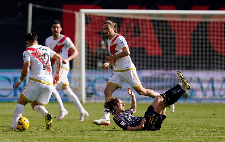 Real Madrid's Luka Modric in action with Rayo Vallecano's Alfonso Espino. - REUTERS PIC
