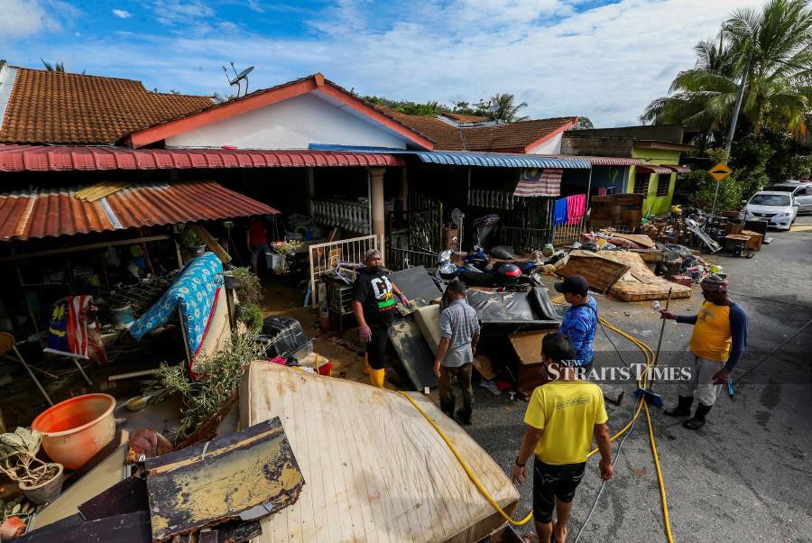 Volunteers and local residents in Taman Pinggiran Felda Sungai Kelamah, Gemas help clean houses affected by the floods. -NSTP/AZRUL EDHAM MOHD AMINUDDIN