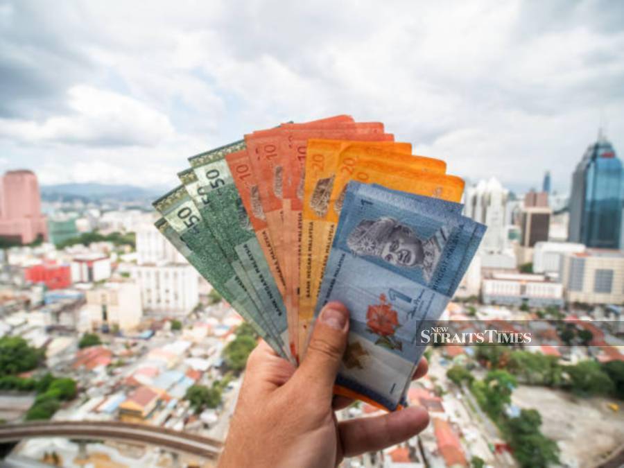 The ringgit opened marginally lower against the US dollar today as investors remain cautious while waiting for forward guidance amid global market volatility, said an analyst.