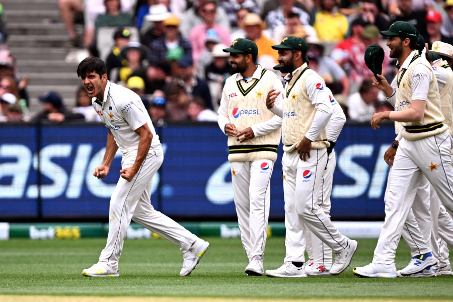 Pakistan bowler Mir Hamza (L) celebrates with teammates after dismissing Australian batsman Travis Head on the third day of the second cricket Test match between Australia and Pakistan at the Melbourne Cricket Ground (MCG) in Melbourne. - AFP PIC