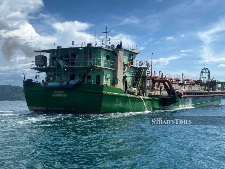 The sand dredging vessel which was seized by Kota Kinabalu marine police after it was caught operating illegally at Usukan island, off the waters of Kota Belud. - Pic courtesy of the Marine Police Force.
