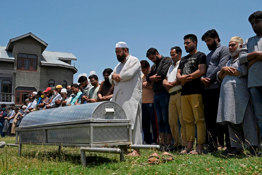 Relatives and neighbours offer funeral prayers for Bashir Ahmed, a civilian who died during a gun-battle between government forces and suspected militants, in Srinagar on July 1. - AFP pic