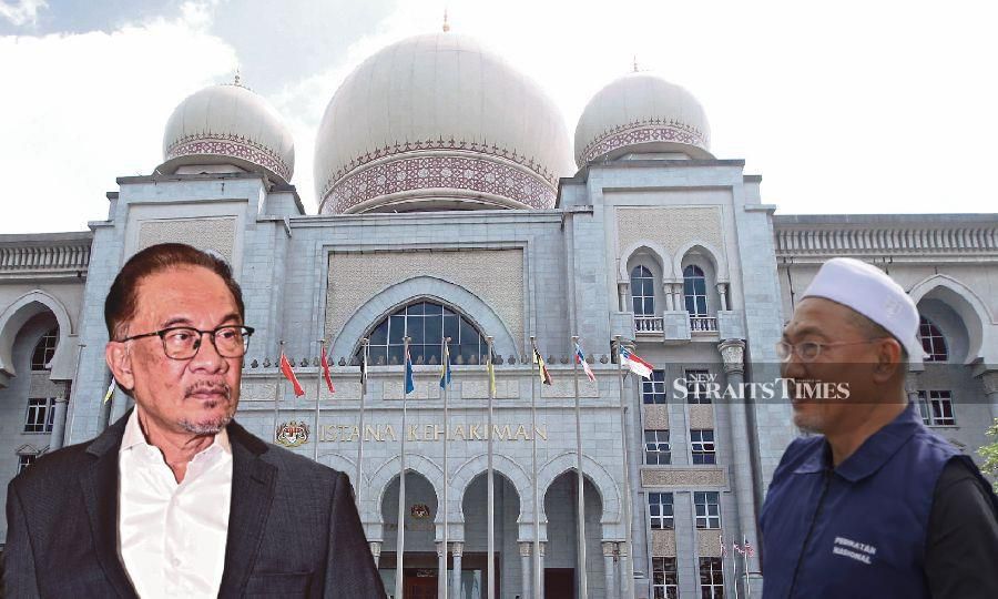 Prime Minister Datuk Seri Anwar Ibrahim filed the defamation suit against Pendang member of parliament Datuk Awang Solahuddin Hashim (right) on March 3 this year. - NSTP file pic