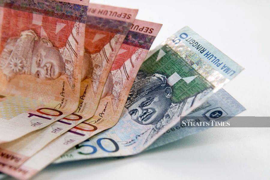 The ringgit opened marginally higher against the US dollar today on weakening demand for the greenback amid volatile sentiment for the local currency, an analyst said. - NST/file pic. 