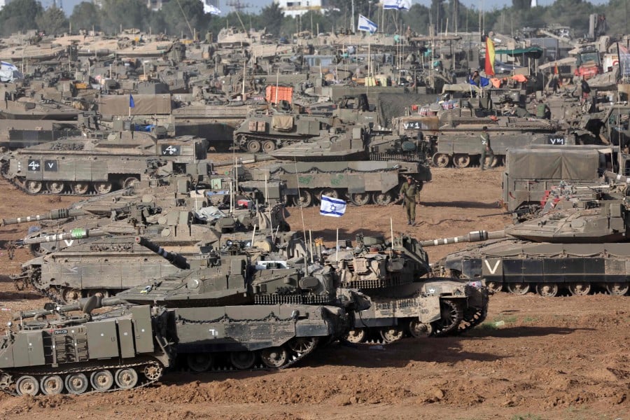 Israeli army battle tanks are positioned in southern Israel near the border with the Gaza Strip. - AFP PIC