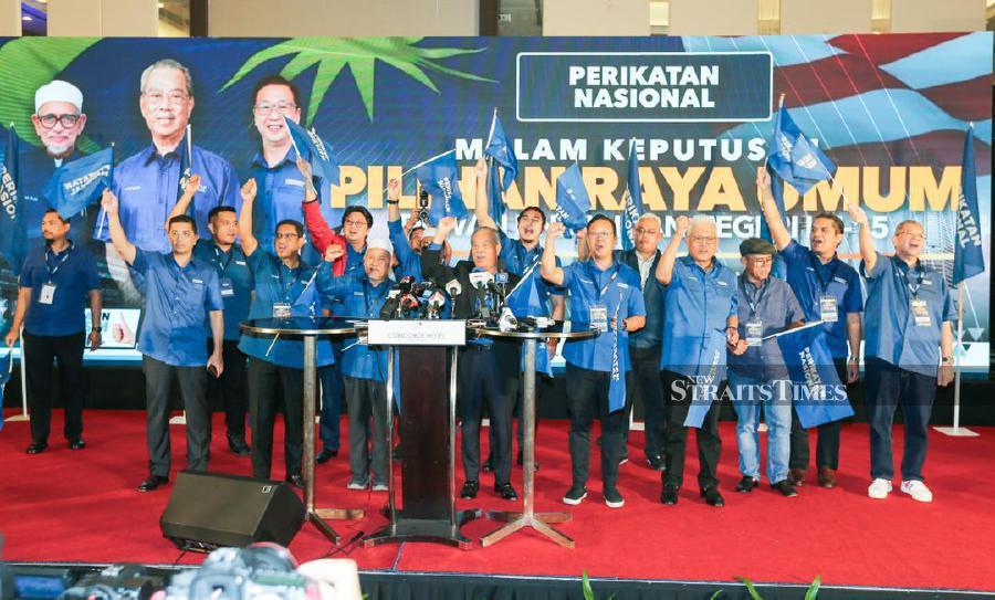 Perikatan Nasional chairman Tan Sri Muhyiddin Yassin with members and candidates gesture following a press conference in Shah Alam, following the state elections. -NSTP/ASWADI ALIAS
