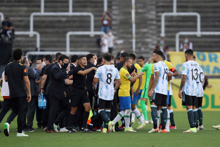 Players and officials are seen on the pitch as play is interrupted after Brazilian health officials objected to the participation of three Argentine players they say broke quarantine rules during a World Cup, South American Qualifiers between Brazil and Argentina, at the Arena Corinthians, Sao Paulo, Brazil on September 5, 2021. -REUTERS PIC