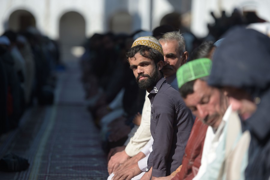 Rozi Khan (centre), a 25-year-old Pakistani waiter who resembles US actor Peter Dinklage, offers Friday prayers at a mosque in Rawalpindi. - AFP