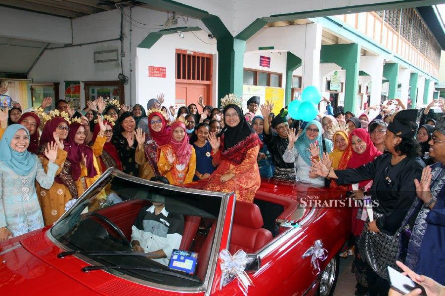 Rosliza Taib sitting in a vintage Mercedes-Benz car before being given a grand send-off by students and teachers. - Pic By VINCENT D’SILVA