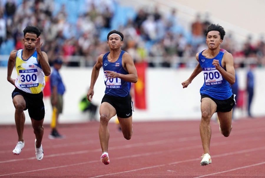 Thailand's Puripol Boonson crosses the line to win the men's 100m final ahead of second place Thailand's Soraoat Dapbang at the My Dinh National Stadium, Hanoi, Vietnam. - REUTERS PIC