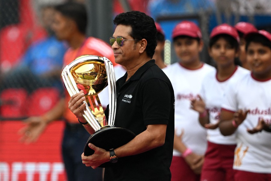 India's former cricket player Sachin Tendulkar carries the World Cup trophy before the start of the 2023 ICC Men's Cricket World Cup one-day international (ODI) first semi-final match between India and New Zealand at the Wankhede Stadium in Mumbai. - AFP PIC