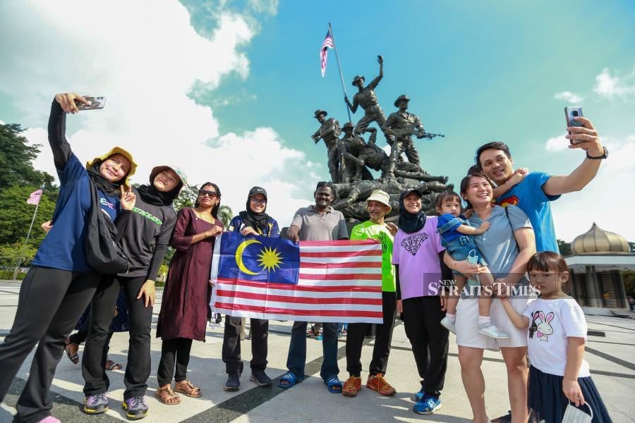 Visitors at the Tuge Negara pose for a group photo during the National Day holiday in Kuala Lumpur. -NSTP/ASWADI ALIAS.