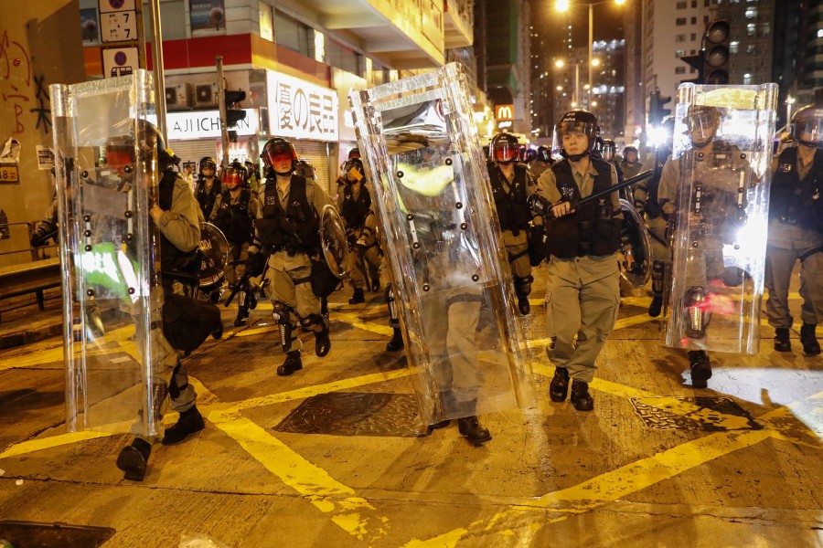  Riot police advance to disperse protesters attending a rally against police's violence at Mong Kok, in Hong Kong. - EPA