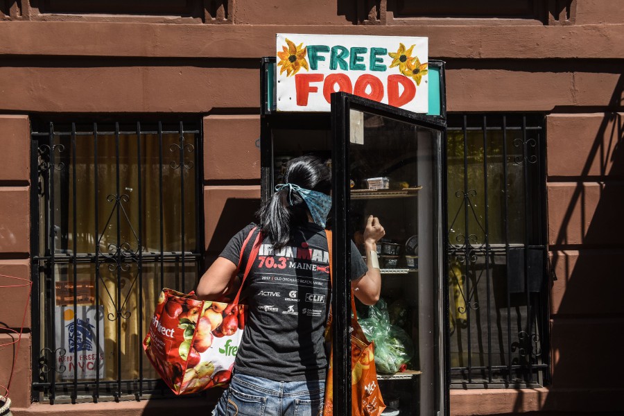  A person wearing a protective mask browses a free food refrigerator on May 5, 2020 in the Bedford-Stuyvesant neighbourhood in the Brooklyn borough in New York City. - AFP