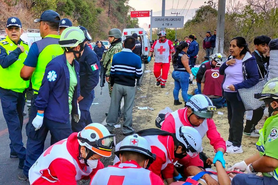 Rescuers attend to victims following the crash in Mexico City, Mexico. - AFP PIC