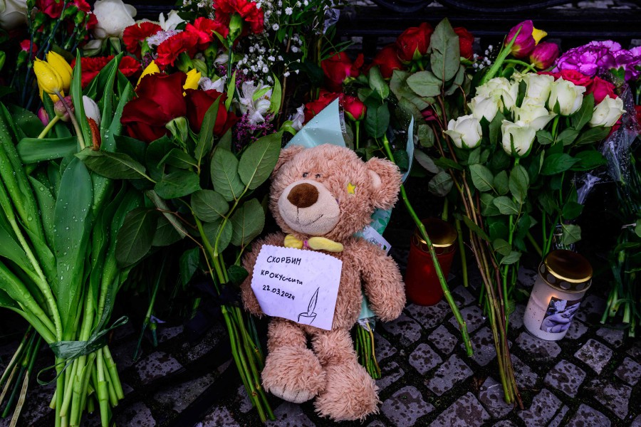A note stuck onto a Teddy bear reads: "Mourning Crocus City" at an improvised memorial outside the Russian embassy in Berlin. - AFP PIC