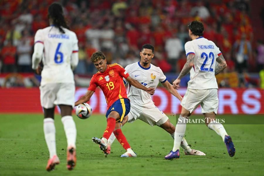 France's William Saliba fouls Spain's forward Lamine Yamal during the UEFA Euro 2024 semi-final football match between Spain and France at the Munich Football Arena in Munich. - AFP PIC