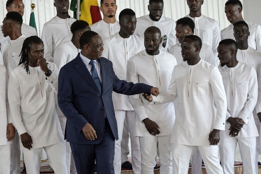 Senegalese President Macky Sall (2L) talk to Senegal's player Sadio Mane (2R) during the presentation of the National flag, at the palace of the republic, in Dakar, on January 9, 2024, before the team leaves for Ivory Coast for the 2024 Africa Cup of Nations (CAN). -AFP PIC