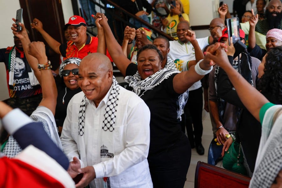 Pro-Palestinian supporters react in celebration after watching the International Court of Justice (ICJ) delivering its decision following a hearing of the case against Israel brought by South Africa in The Hague at the Embassy of Palestine in Pretoria. - AFP PIC