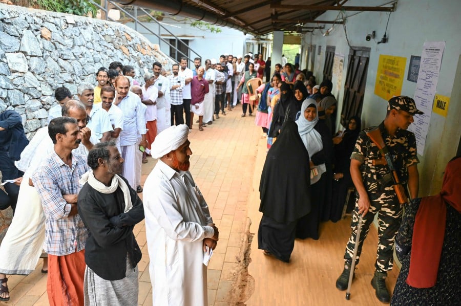 People wait to cast their vote at a polling station during the second phase of voting of India's general elections in Wayanad district in Kerala. - AFP PIC