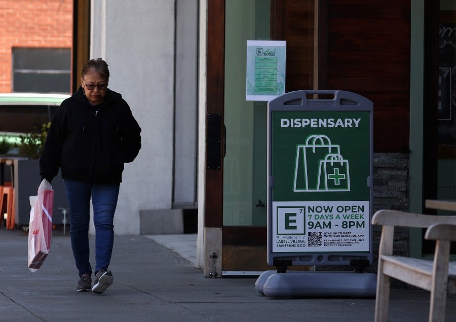  A pedestrian walks by a sign in front of a cannabis dispensary on April 30, 2024 in San Francisco, California. -AFP PIC