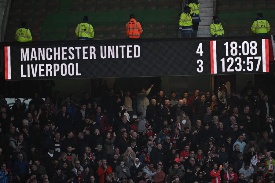 The scoreboard displays the final score after extra-time in the English FA Cup quarterfinal match between Manchester United and Liverpool at Old Trafford in Manchester. - AFP PIC