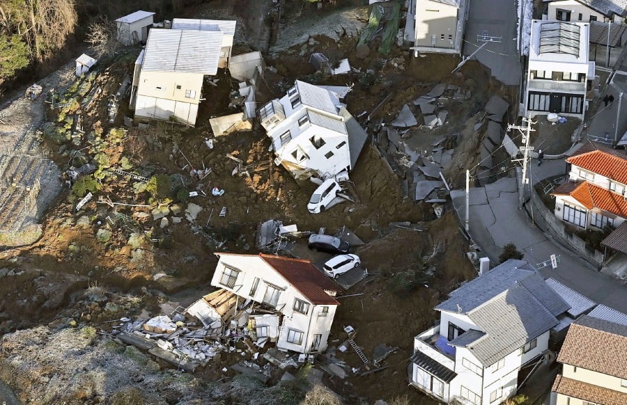 An aerial view shows collapsed houses, cars and roads caused by an earthquake in Kanazawa, Ishikawa prefecture, Japan. - REUTERS PIC