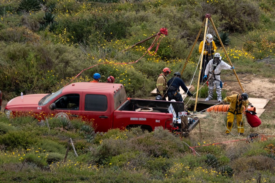 A rescue worker prepares to descend into a waterhole where human remains were found near La Bocana Beach, Santo Tomas delegation, in Ensenada, Baja California State, Mexico. - AFP PIC