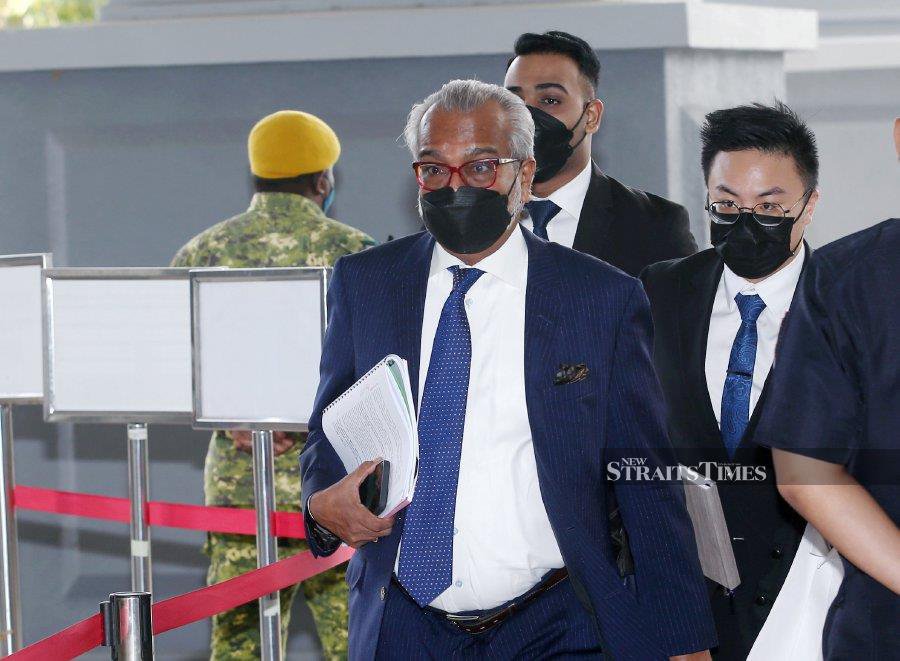 This June 22, 2022 shows Tan Sri Muhammad Shafee Abdullah arriving at the Kuala Lumpur Courts Complex ahead of the 1MDB trial in. - NSTP/EIZAIRI SHAMSUDIN