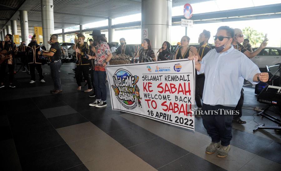 Dancers perform as they welcome passengers at the Kota Kinabalu International Airport. - NSTP/MOHD ADAM ARININ