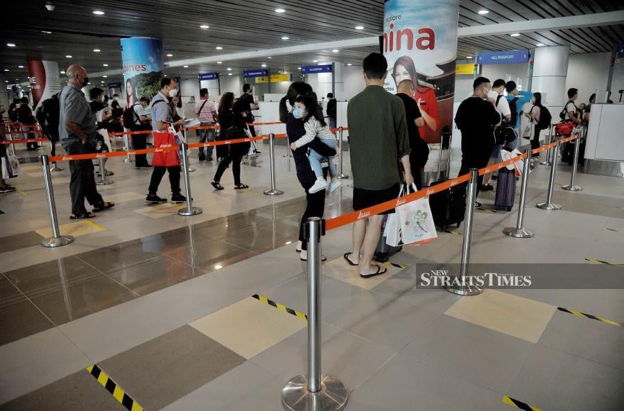 Passengers lining up at the immigration counters at the Kota Kinabalu International Airport. - NSTP/MOHD ADAM ARININ